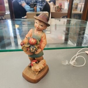 ANRI Figurine with boy Holding Basket of Fruits With A Chicken